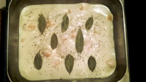 Ready to go into the oven, with a sprinkling of black pepper and bay leaves.
